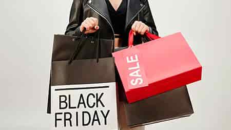 Woman carying black friday shopping bags